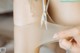 A close up of a person cutting a piece of fabric with scissors.