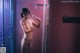 A naked woman taking a shower in a bathroom.