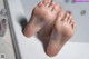 A close up of a person's feet in a bathtub.