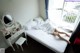 A woman laying on a bed in a hotel room.